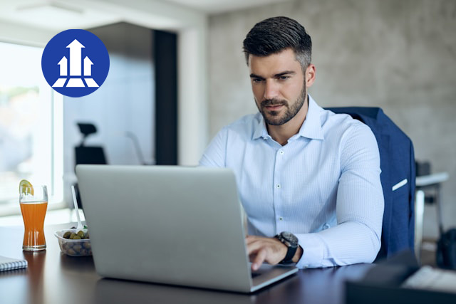 A man working on his laptop, looking focused