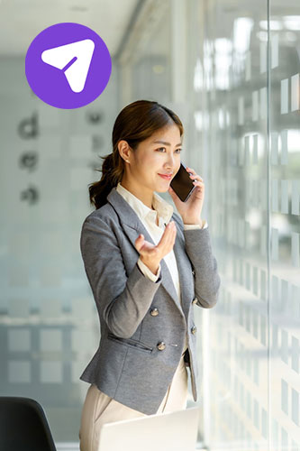 Asian lady on the phone at a workplace